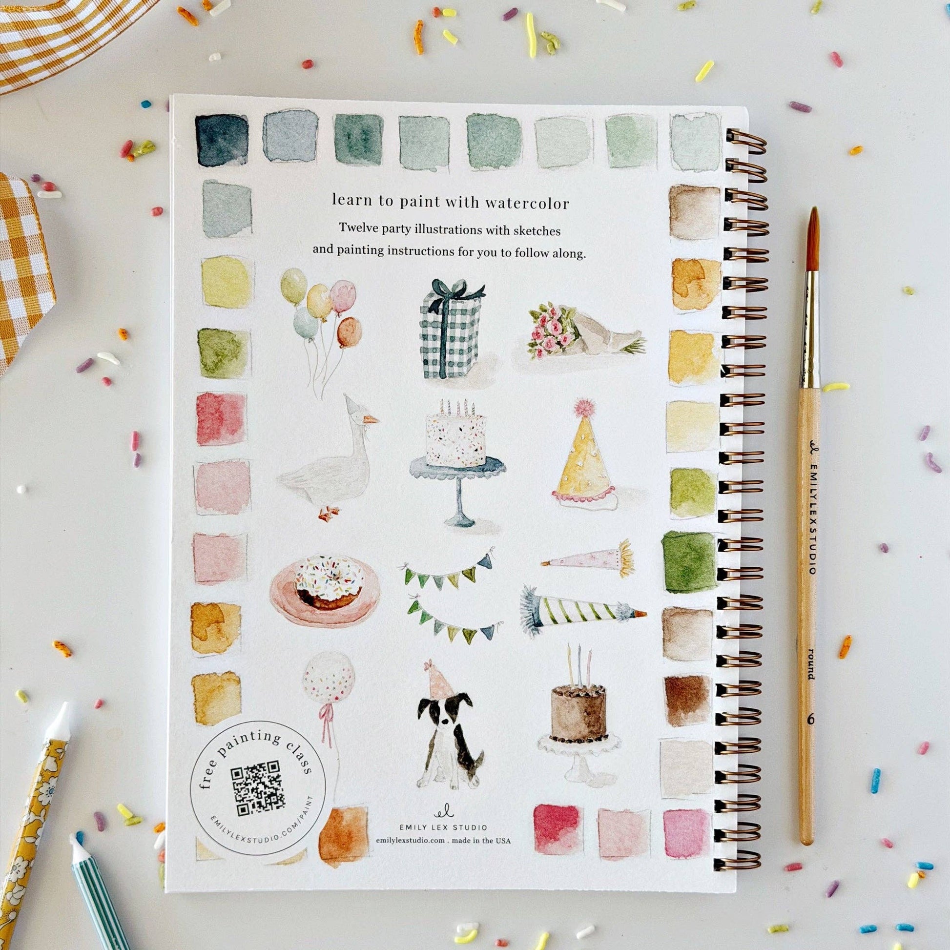 The Celebrate watercolor workbook is a spiral-bound painting guide for beginners, featuring party-themed illustrations with watercolor swatches. Sizes available.