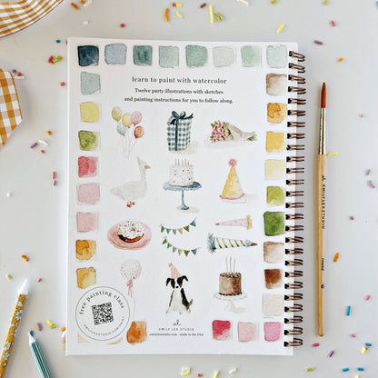The Celebrate watercolor workbook is a spiral-bound painting guide for beginners, featuring party-themed illustrations with watercolor swatches. Sizes available.