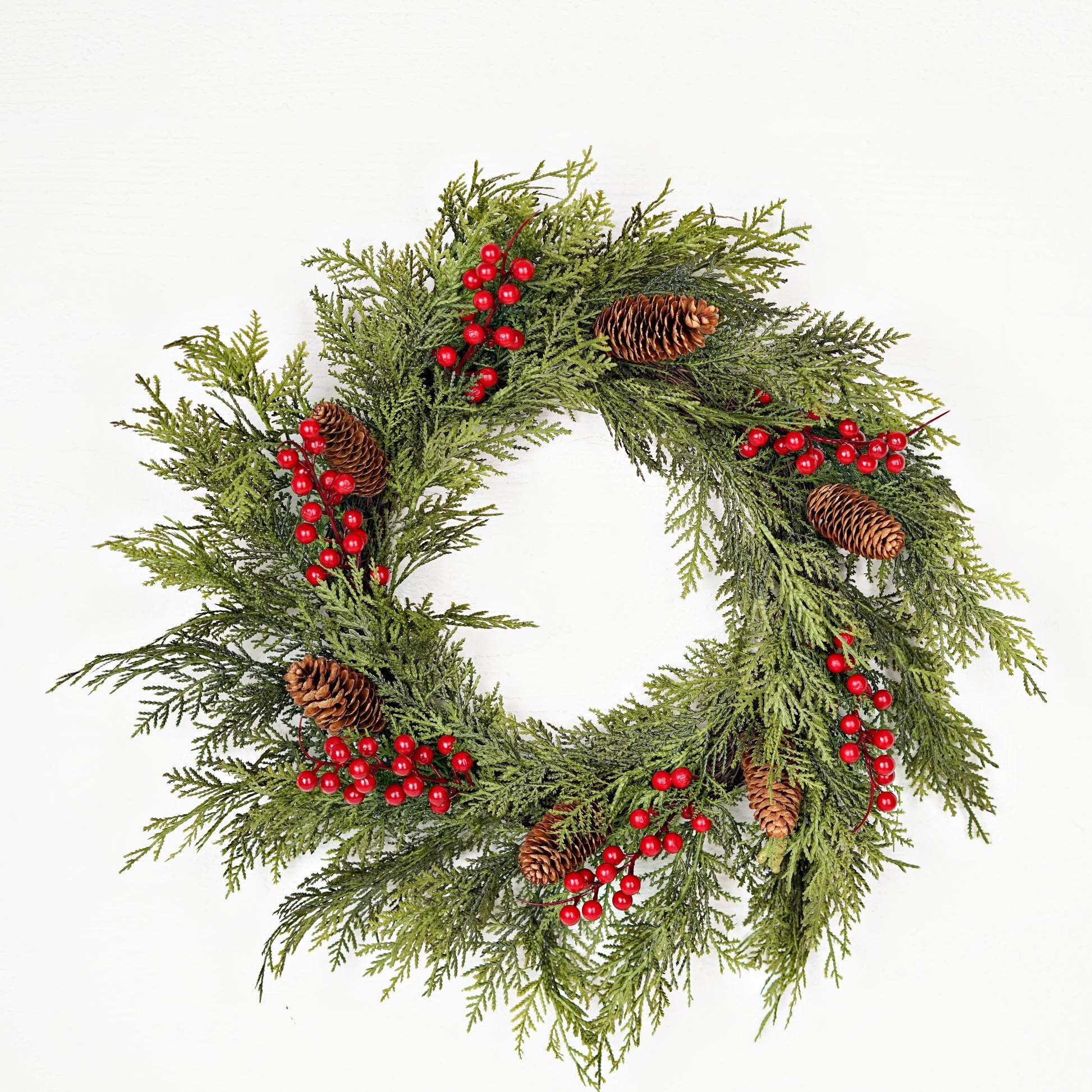 510050 - 22in Twig Wreath with real touch mixed cedar, green pine branches, red berry accents, and brown pinecones. Available in 22 inches.