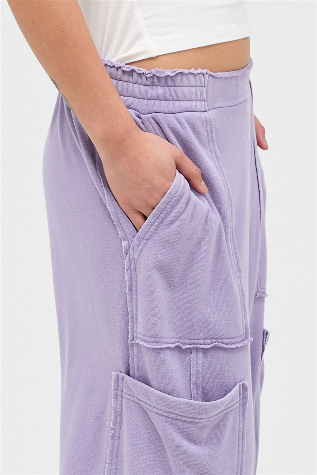 Mineral Wash Wide Leg Cargo Pants in light purple with raw edge seams and large pockets. Sizes: XS-XL.