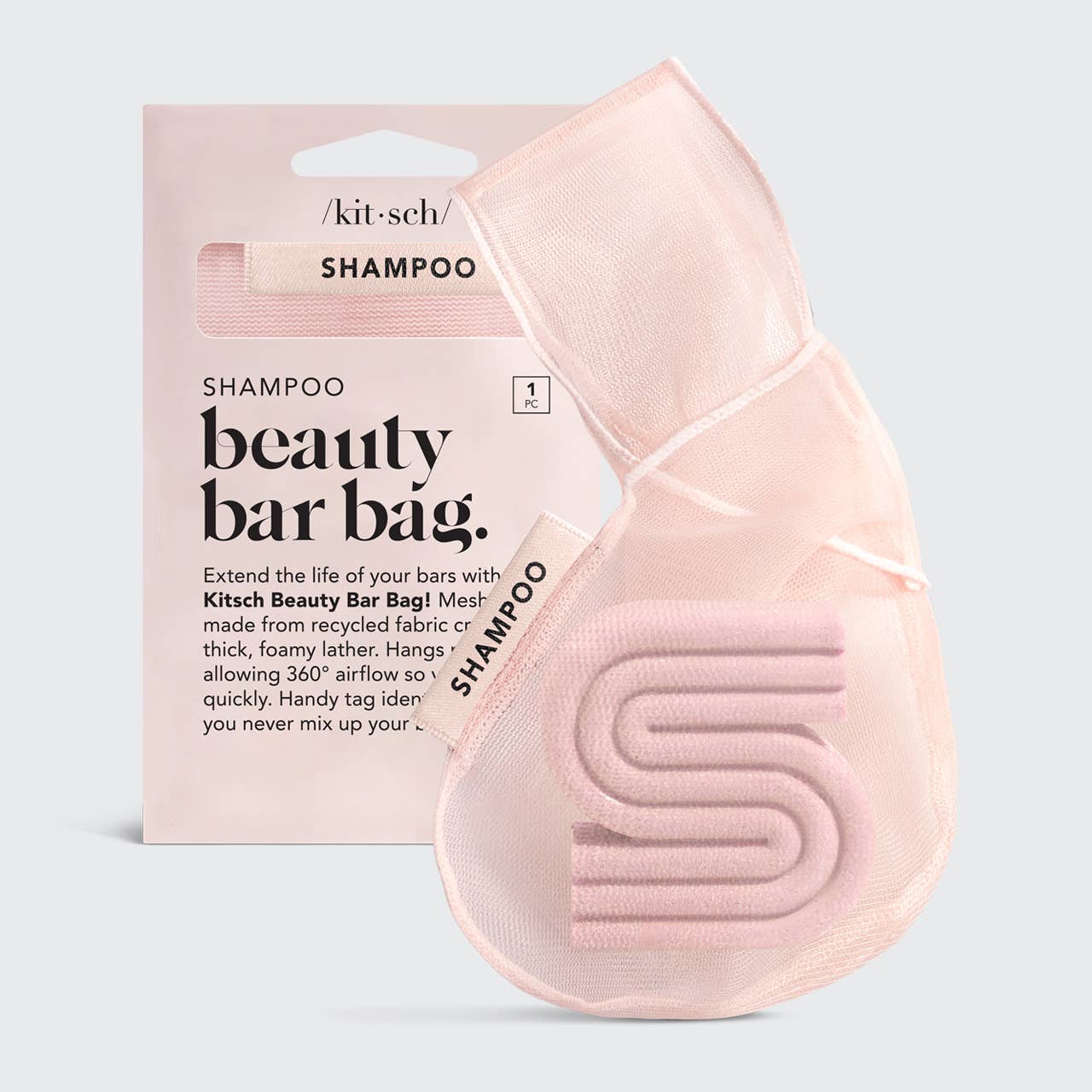 Light pink mesh zippered bag labeled "SHAMPOO," with curved design and fabric loop. Sizes available: standard and large.