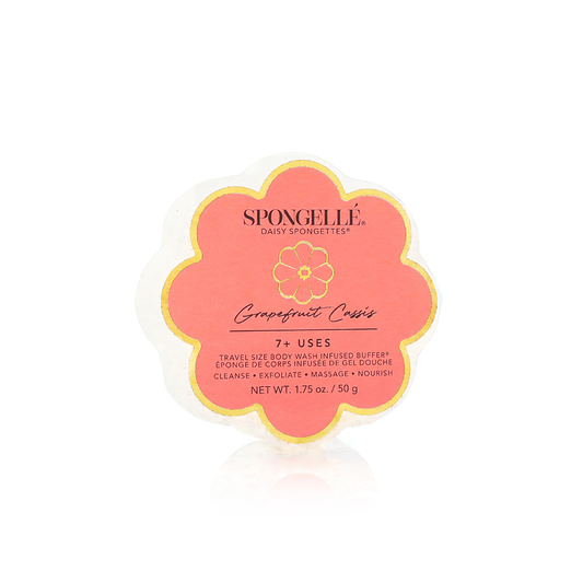 Flower-shaped white soap sponge, "7+ uses" pink/gold label. Used for cleansing, exfoliating, massaging. Available in standard size.