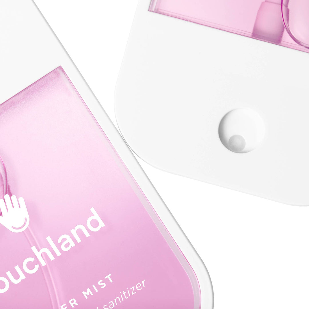 Two translucent pink Berry Bliss Power Mist Hydrating Hand Sanitizer spray bottles.