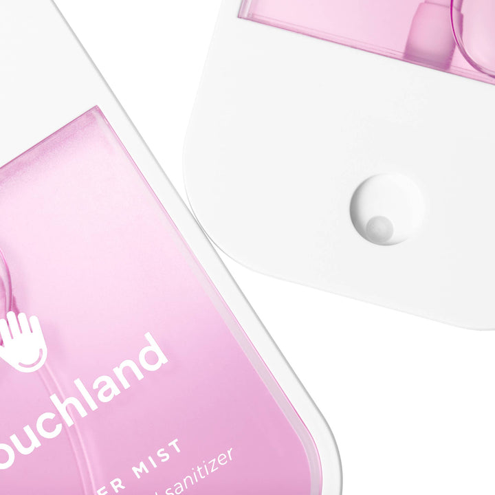 Two translucent pink Berry Bliss Power Mist Hydrating Hand Sanitizer spray bottles.