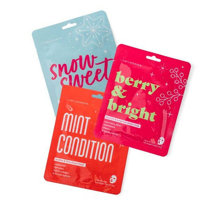 Set of three single-use Lemon Lavender Let It Glow Holiday Face Masks in light blue (“snow sweet”), red (“mint condition”), and bright pink (“berry & bright”) packets with festive designs and bold lettering; available in one size. Made in Korea.