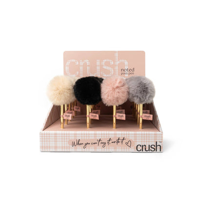 Crush Noted Pom Pens with fluffy pom-pom toppers in beige, black, light pink, or gray and sleek goldtone barrels. Black ballpoint ink. Available in standard pen size only.