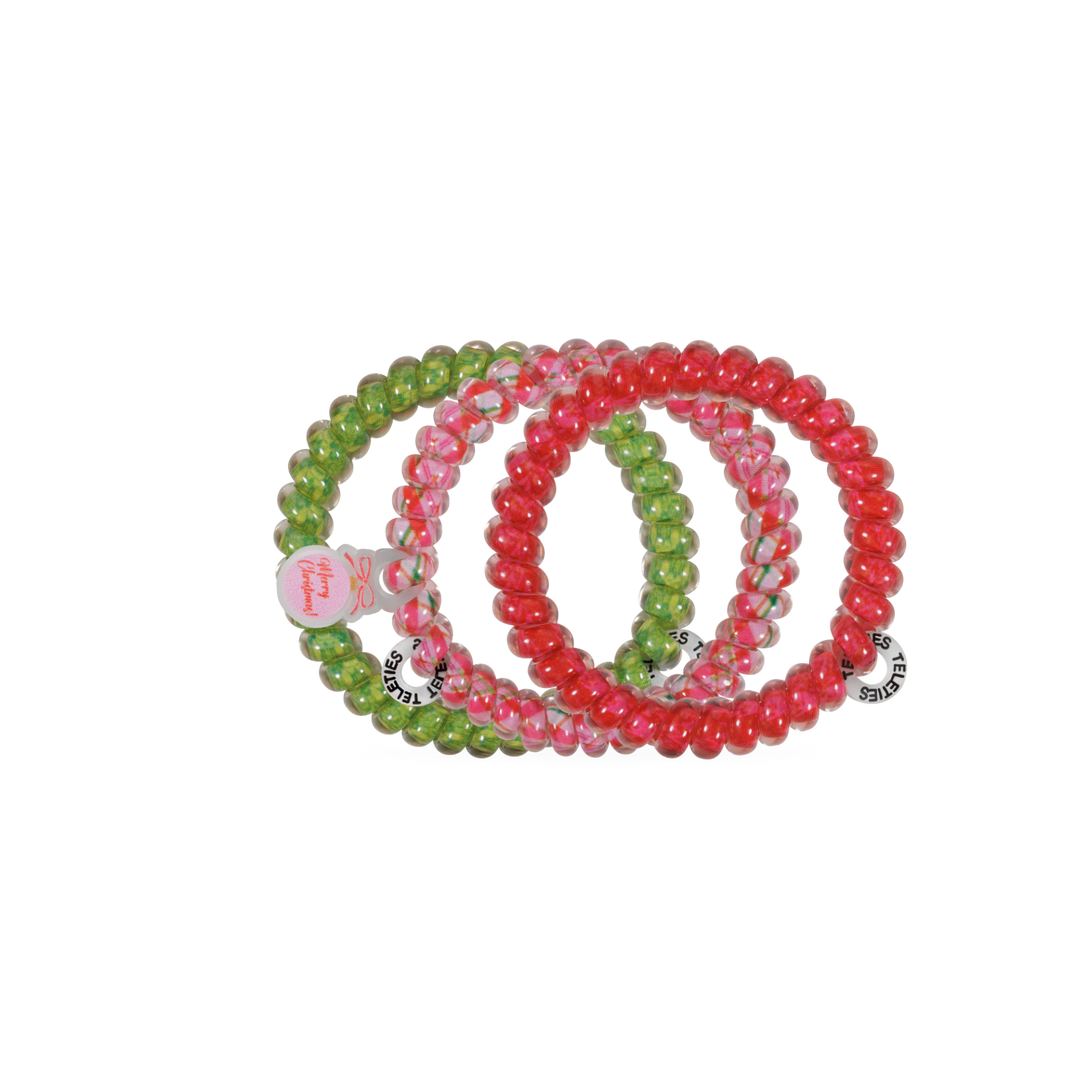 Three And to All a Good Night hair ties, small, red and green spiral coils with “Merry Christmas” tags for no-crease hold.