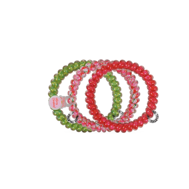 Three And to All a Good Night hair ties, small, red and green spiral coils with “Merry Christmas” tags for no-crease hold.