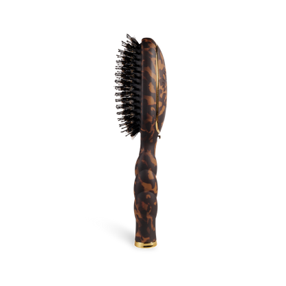 The Boar Bristle Hair Brush | Tortoise has a tortoiseshell handle, black boar bristles. Available in regular and travel sizes.