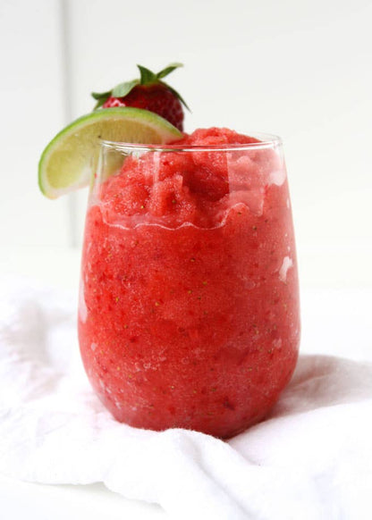 Red frozen strawberry drink in a clear glass, made from Wine & Cocktail Slush Mix Bags. Available in 8oz, 16oz, and 32oz sizes.