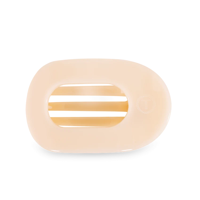 A beige TELETIES Flat Round Hair Clip designed with slotted openings for drainage. Available sizes: Small, Large.
