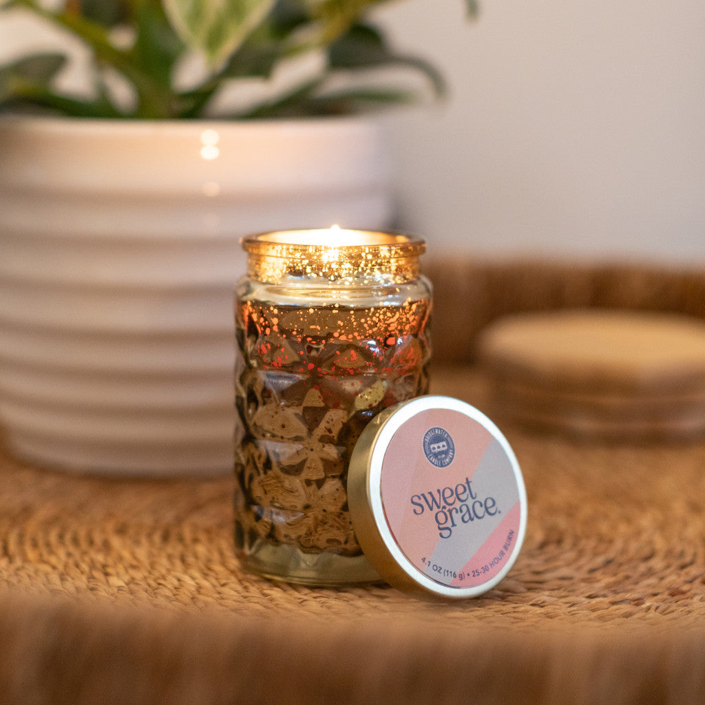 Sweet Grace Candle #022 features a textured glass jar with premium fragrance and soy-blend wax. Available size: 16 oz.