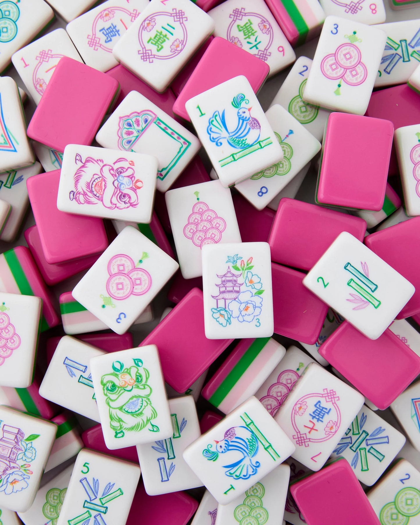 Amara Mahjong Tiles, white with pink backs, feature floral designs. Available sizes: Standard and Large.