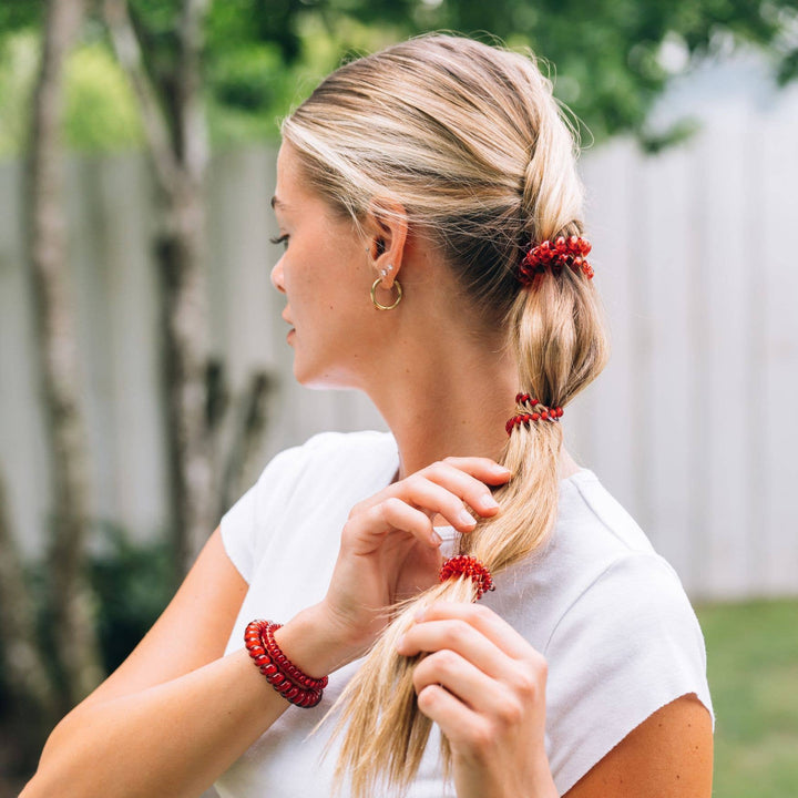 Red Carpet Ready Spiral Hair Coils shown in blonde hair low ponytail; available in small and large sizes.