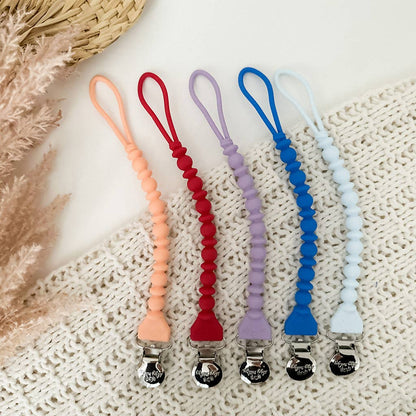 Five Sweetie Strap™ Silicone One-Piece Pacifier Clips in Hero Blue beaded style; available in one size.