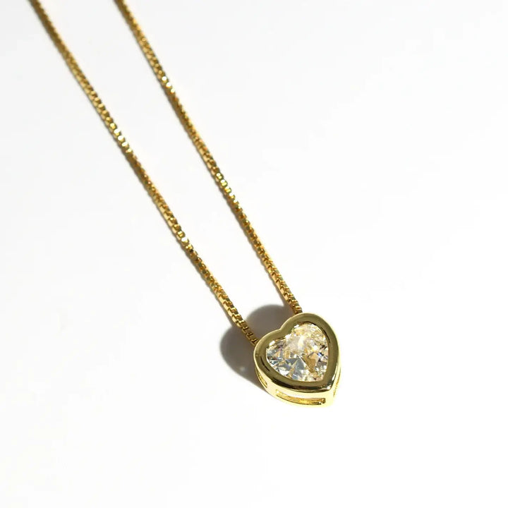 Elegant silver chain necklace with heart-shaped pendant and sparkling diamond. Available sizes: 16", 18", 20".
