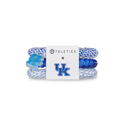 Three blue and white TELETIES Hair Ties with TELETIES and “UK” logos. Available in small, medium, large sizes.