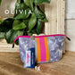 The Olivia Small Neoprene Makeup Bag by Taylor Gray has pink, orange, yellow stripes on gray-white camo. Size: small.