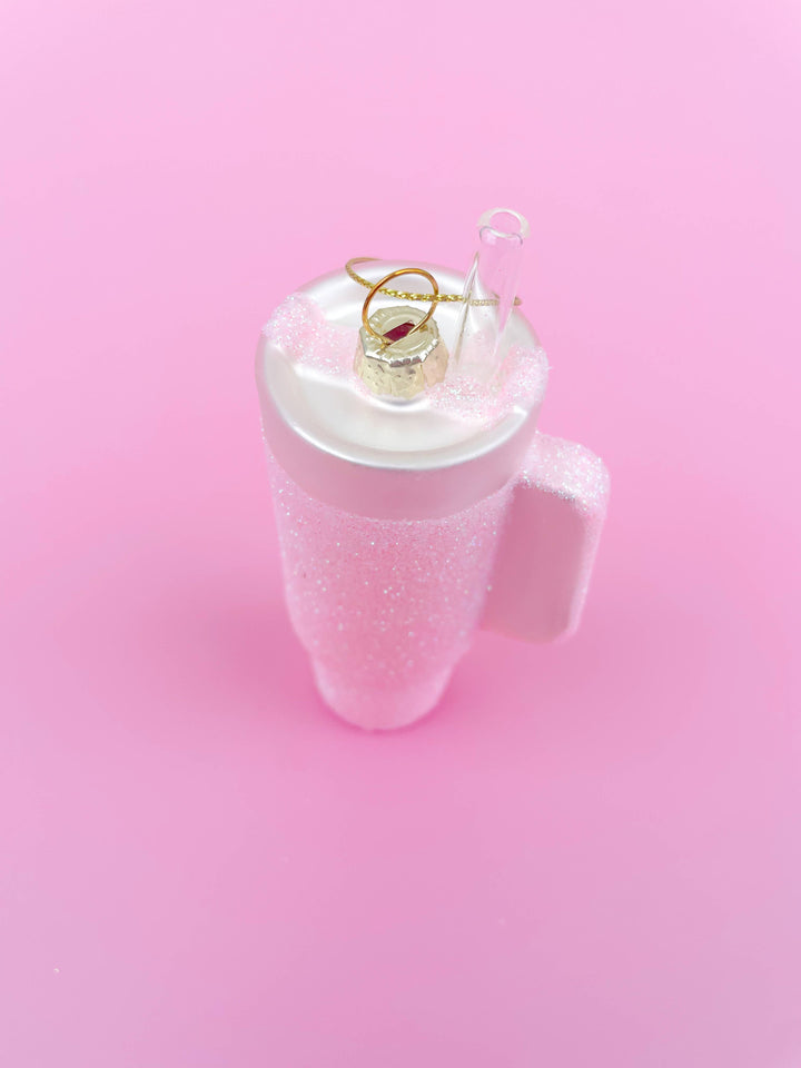 Pink glittered tumbler Christmas ornament with clear straw and gold hanging loop.
