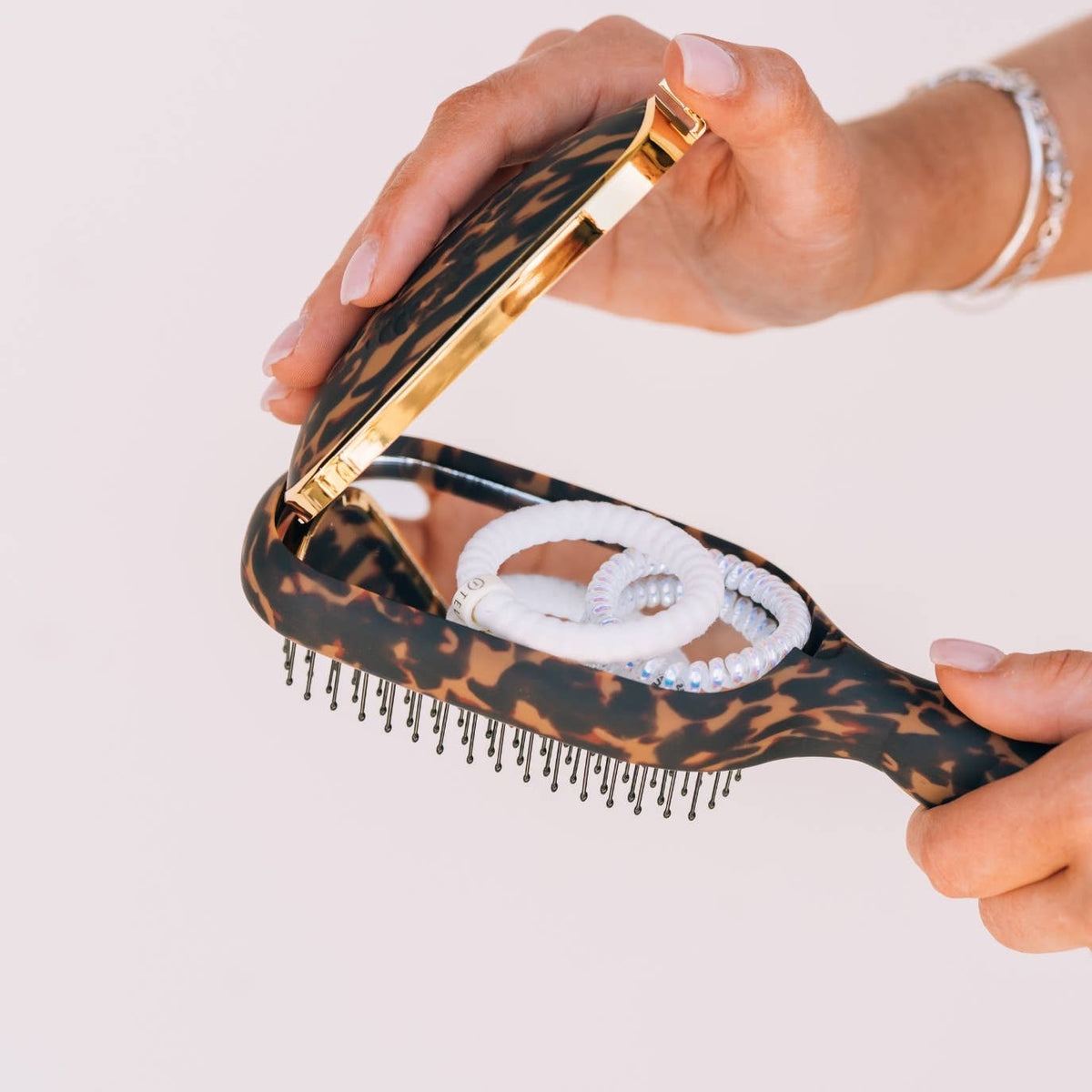 Detangler Hair Brush for Thick Hair - Tortoise, features a hidden compartment for accessories. Available in multiple sizes.