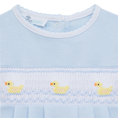 Light blue bubble with chest smocking, hand-embroidered ducklings, and “pixbaby” tag inside collar. Available in multiple sizes.