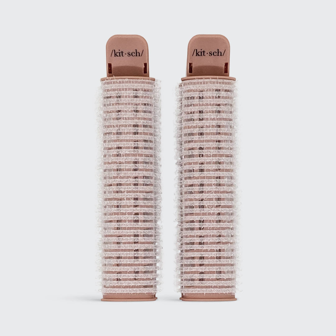 Two pink Volumizing Roller Clips with white bristles, "/kit·sch/" labeled. Available in small and large sizes.