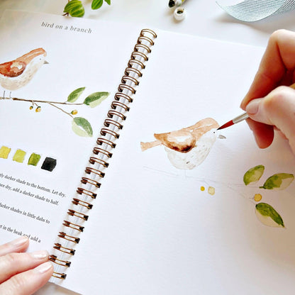Animals Watercolor Workbook spiral-bound sketchbook with animal art, color swatches, and instructions; sizes: standard, large.