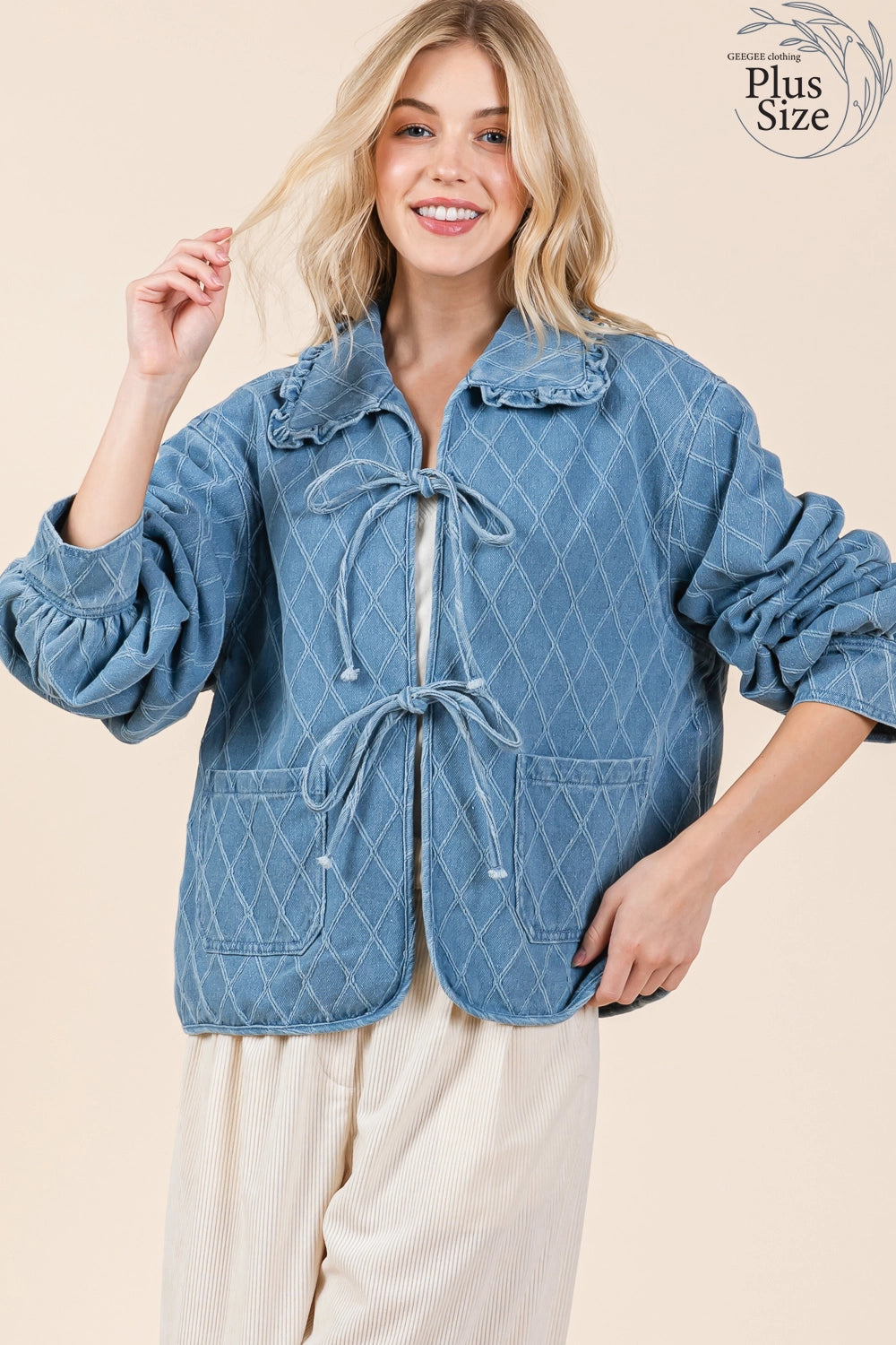 The Quilted Denim Jacket is a blue jacket with a tie closure and large ruffle hem collar. Available in plus sizes.