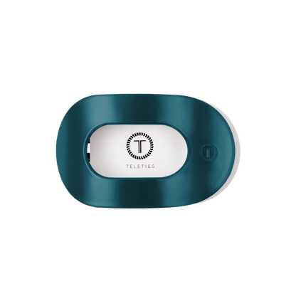 Teal “Teal With It Medium Flat Round Hair Clip” by TELETIES, oval-shaped with a rectangular center opening, features the TELETIES logo and name inside; available in medium size.