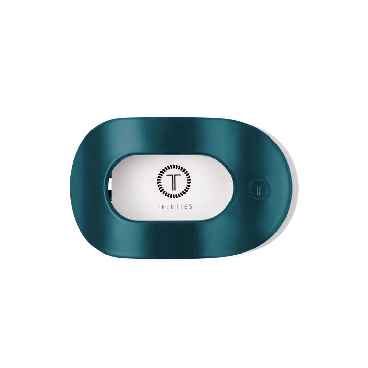 Teal “Teal With It Medium Flat Round Hair Clip” by TELETIES, oval-shaped with a rectangular center opening, features the TELETIES logo and name inside; available in medium size.