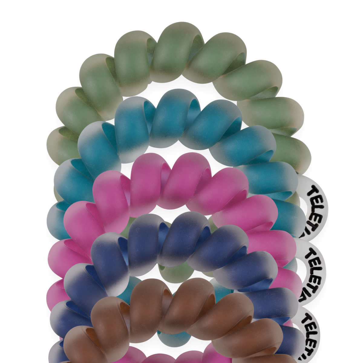 Set of five coiled, frosted Tiny Hair Ties in green, blue, purple, pink, and brown, each with a round white tag. Available in kids and fine hair sizes.