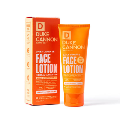 Orange tube of Daily Defense Face Lotion, mineral sunscreen SPF 32, dermatologist tested. Sizes: 2oz, 3.4oz. Supports veterans.