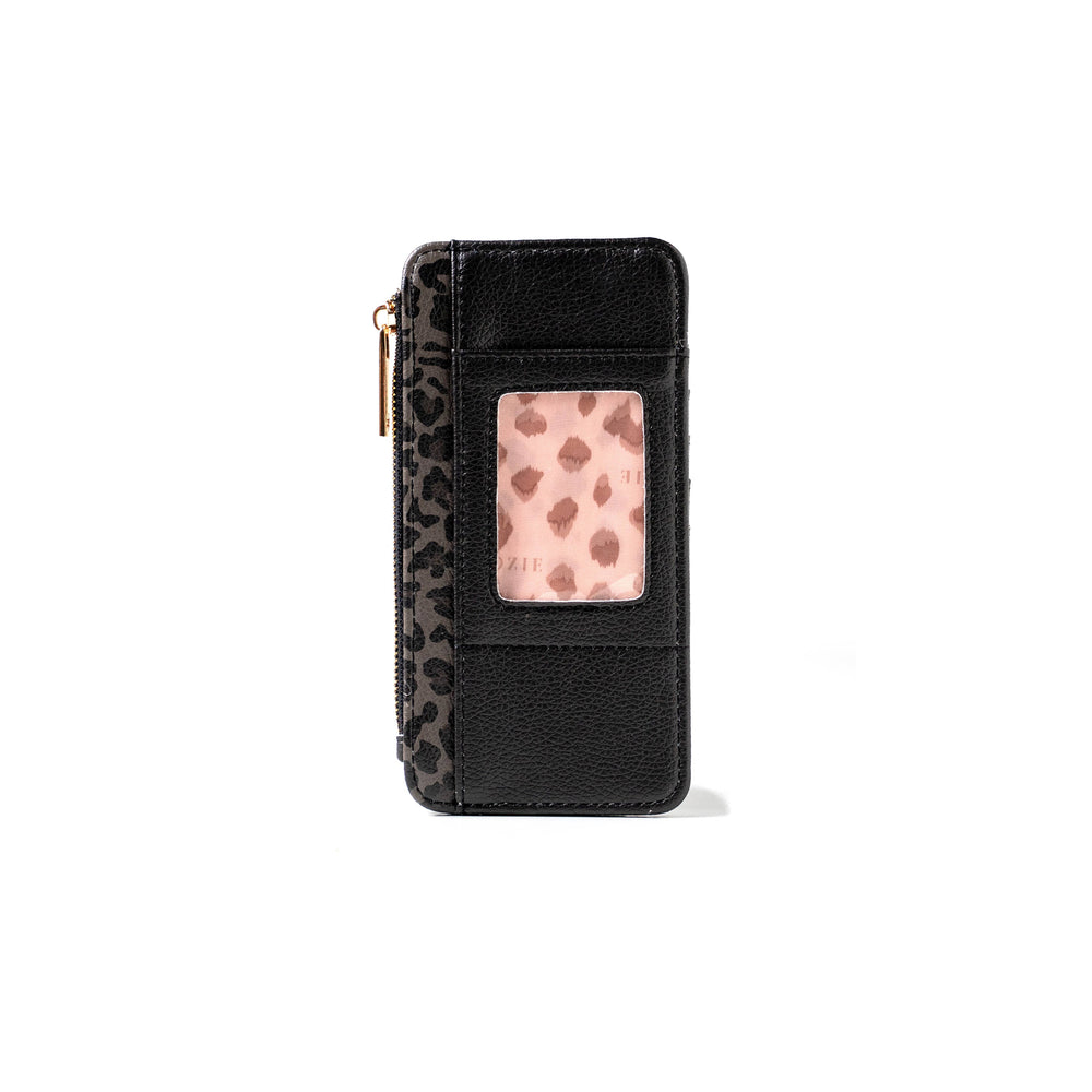 The Kedzie Essentials Only Zippered Wallet Open Stock: Wild Card is a compact black vegan leather wallet with a zipper, transparent ID slot, and leopard print detailing. Sizes available.
