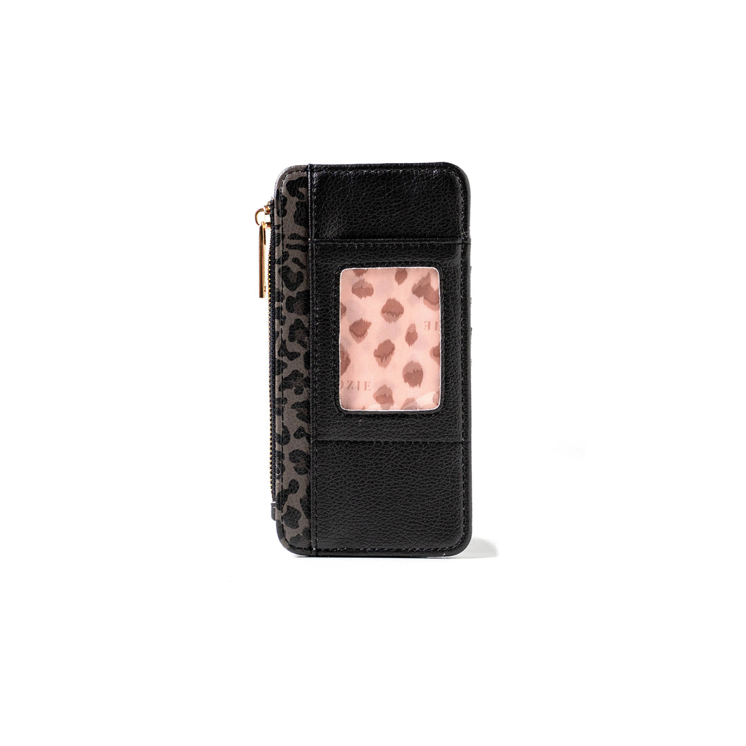 The Kedzie Essentials Only Zippered Wallet Open Stock: Wild Card is a compact black vegan leather wallet with a zipper, transparent ID slot, and leopard print detailing. Sizes available.