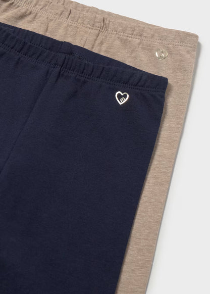 2-pack set of little girl’s cotton leggings with elastic waists—one navy blue with a small heart logo, one light brown. Available in sizes 2T-6X.