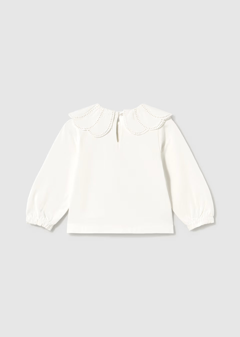 White long-sleeve blouse with a scalloped embroidered Peter Pan collar, eyelet trim, back button keyhole, and gathered balloon cuffs. Available in sizes 2T-6Y.