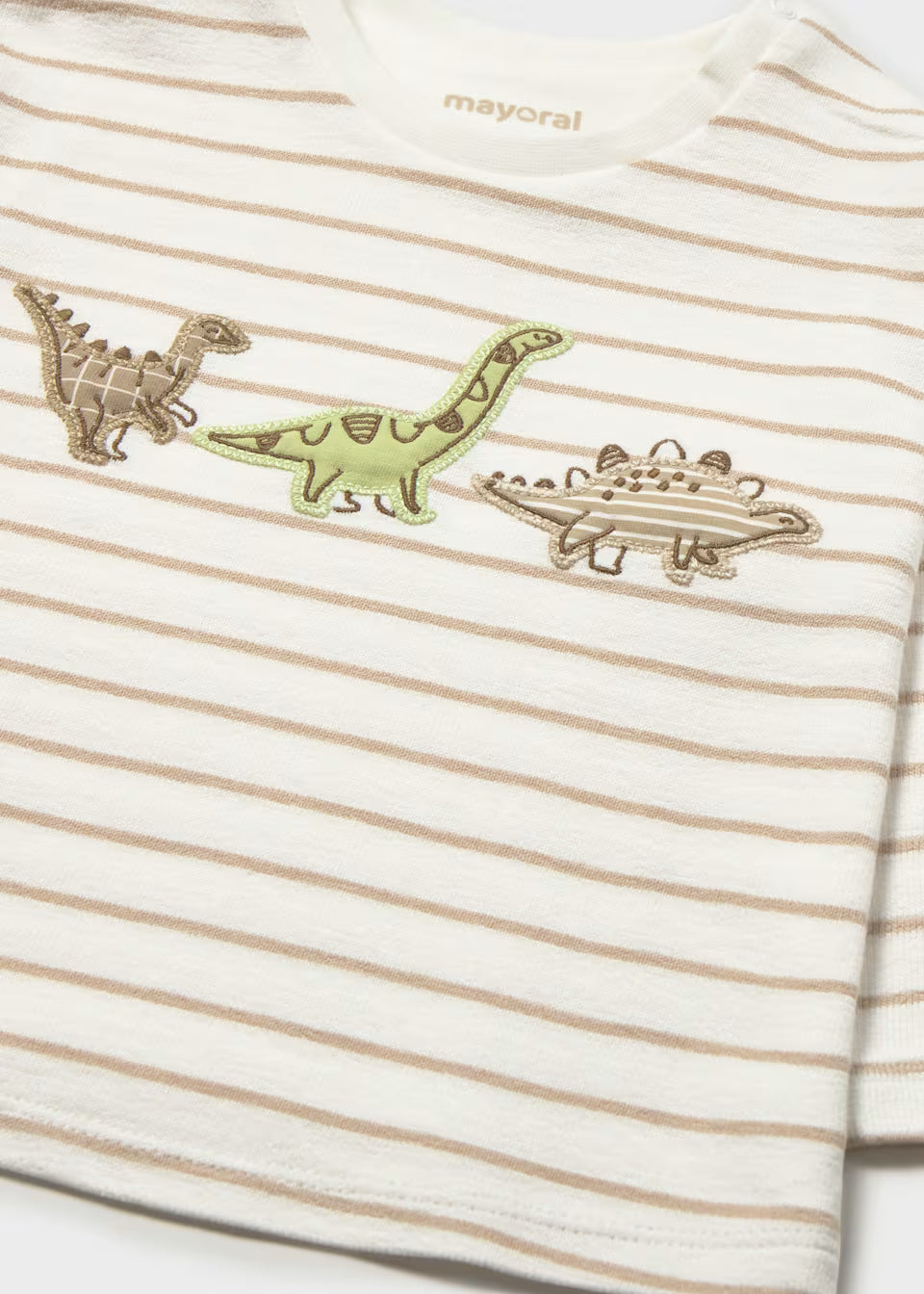 White and beige striped 100% cotton long sleeve children’s shirt with three embroidered dinosaurs (brown, green, gray) on the chest; available in sizes 2T–5T.