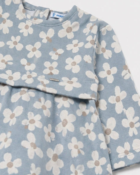 Light blue jacquard dress with long sleeves, white and beige daisy print, back button closure, and silver tag at front waist. Available in sizes 2T-6X.