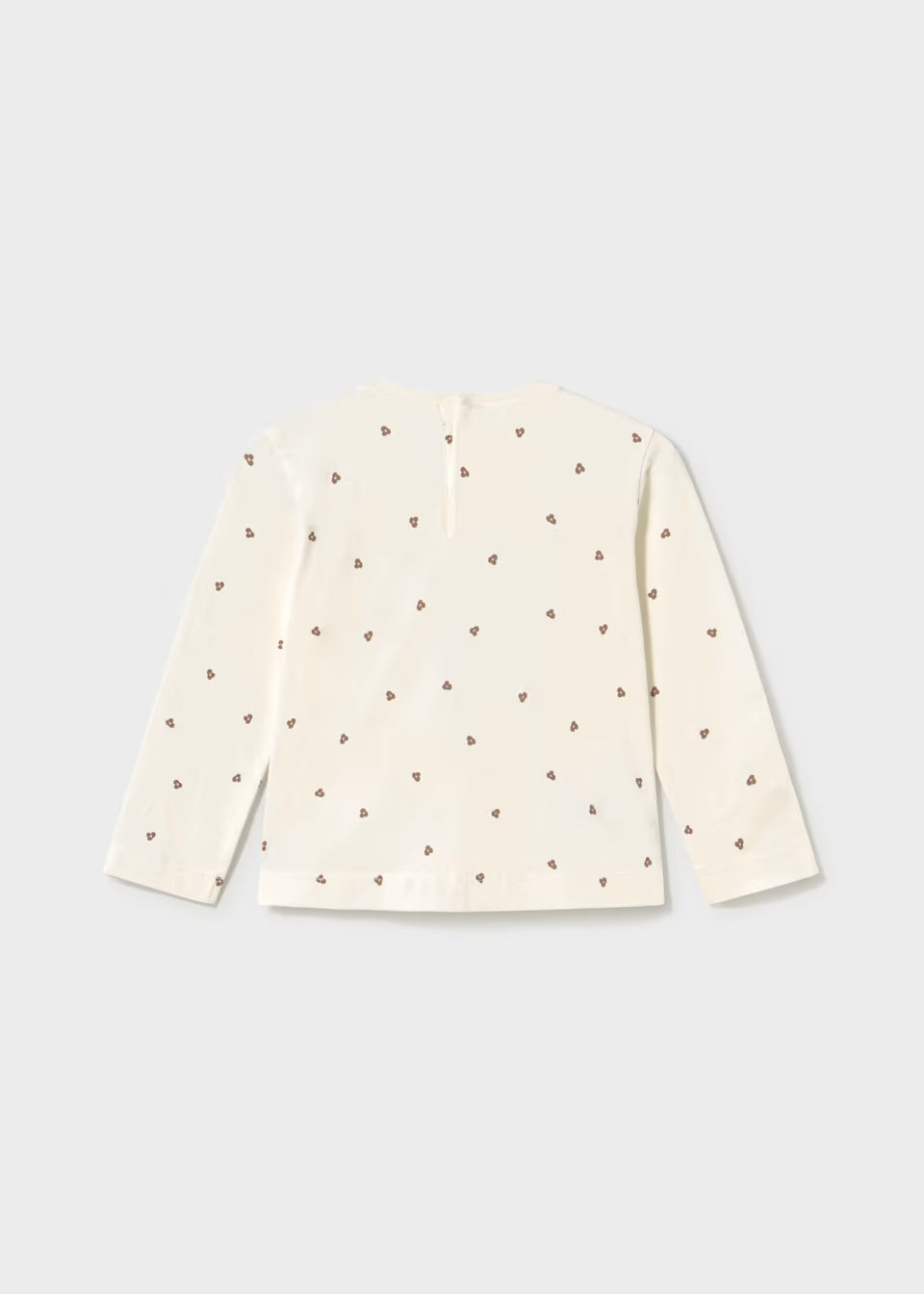 Cream long sleeve T-shirt with straight hem, decorated on the back with small brown heart patterns and glitter dots. Available in sizes 2T-6T.