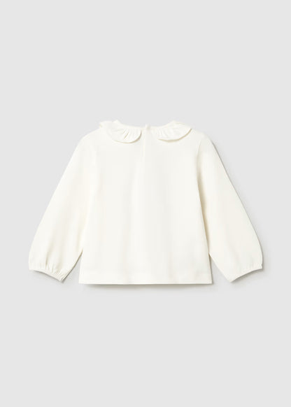 White, loose fit long sleeve T-shirt with elasticized cuffs and a ruffled Peter Pan collar. Available in sizes 80-120.