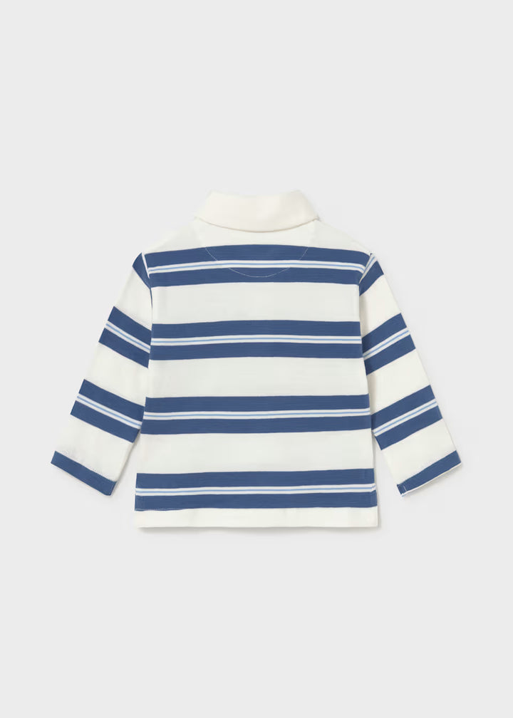 Back view of the Little Boy Indigo Striped Long Sleeve Polo, a cotton children’s shirt with wide indigo stripes and white accents. Collared, long sleeves. Available in sizes 2T-7.