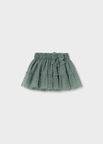Laurel Green Baby Tulle Skirt with elastic waistband, decorative bow, embroidered hearts, small dotted pattern, and layered ruffle design. Available in sizes 0-3M, 3-6M, 6-12M, and 12-24M.