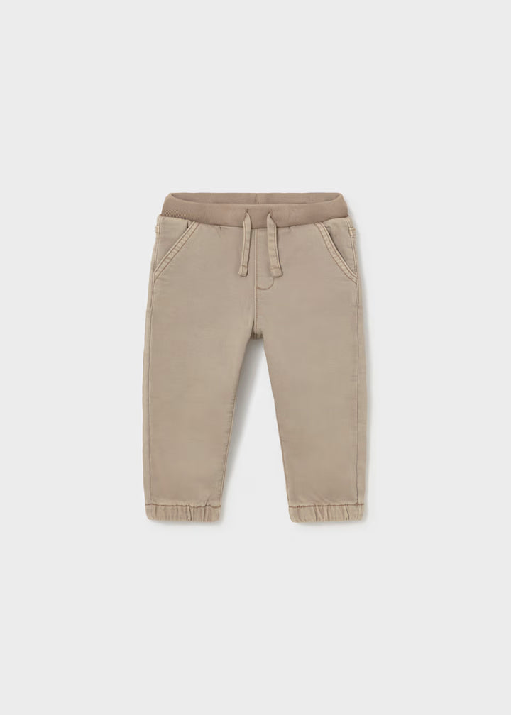 Beige twill jogger pants for toddlers with elastic waistband, drawstring, side pockets, and elastic cuffs. Available in sizes 2T-5T.