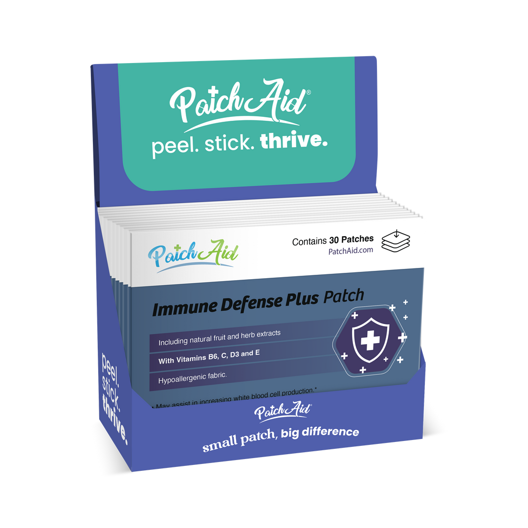 A blue PatchAid display box contains Immune Defense Plus Patch - Immune Support with Zinc &amp; C, D in 1-pack size. Labels show a shield icon and list health benefits. The box displays the slogans “peel. stick. thrive.” and “small patch, big difference.”.