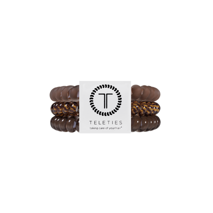 Set of three TELETIES Morning Brew Small Hair Ties with a brown spiral coil design and a white branded label at the center. Available in small size. Waterproof, no-crease, and designed to prevent dents and kinks.