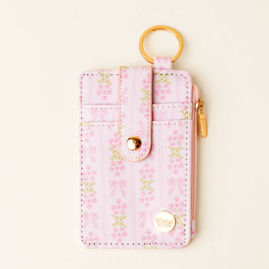 Pink floral keychain wallet with gold keyring, snap closure, side zip pocket, and gold "Angelic Pretty" emblem. Sizes: S/M/L.