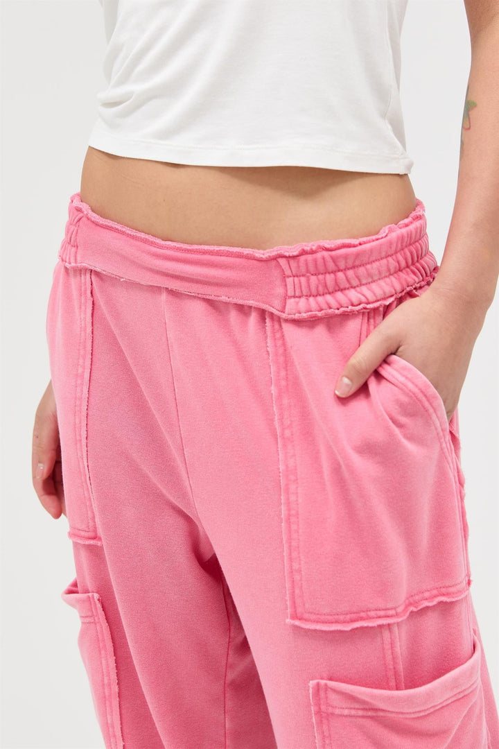 Bright pink Mineral Wash Wide Leg Cargo Pants with large patch pockets and raw seams. Available in XS-XL.