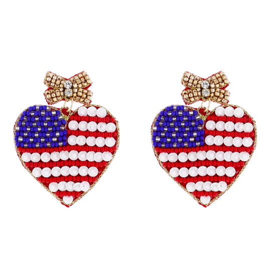 Heart-shaped earrings with red, white, and blue beads, gold bow accent. Sizes: small, medium. USA flag inspired design.