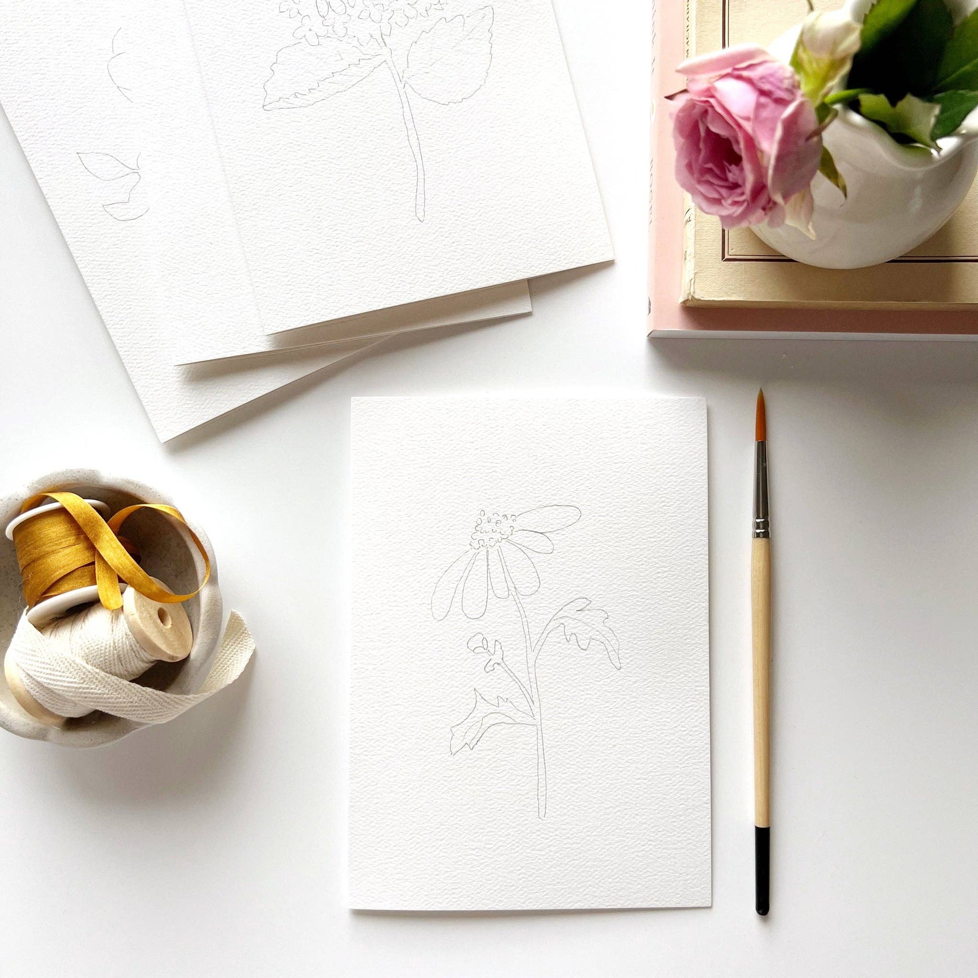 Garden Flowers Paintable Notecards, set of 8, each featuring a flower sketch on white paper. Available in standard size.