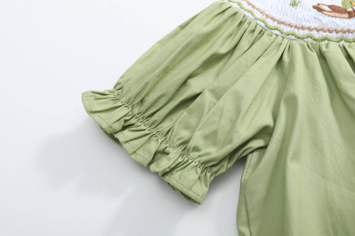Pistachio Green Mallard Duck Smocked Bishop Dress, size 12-18M, with puffed sleeve, gathered stitching, ruffled edge, and partial embroidered pattern.